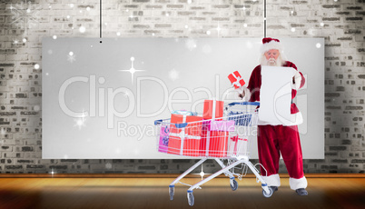 Composite image of santa delivering gifts from cart