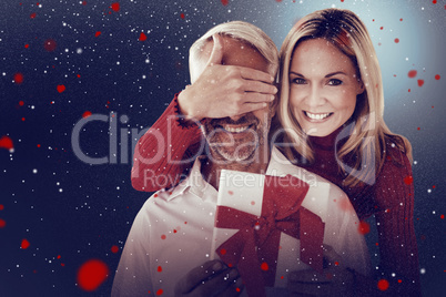 Composite image of loving couple with gift