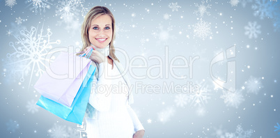 Composite image of handsome woman holding shopping bags against