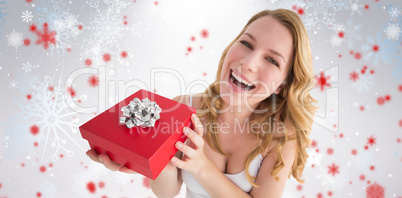 Composite image of portrait of a happy woman receiving a present