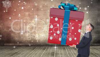 Composite image of stylish man with giant gift