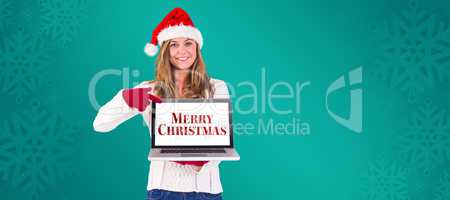 Composite image of festive blonde pointing to laptop