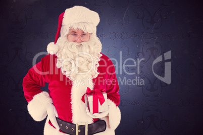 Composite image of happy santa claus holding a gift