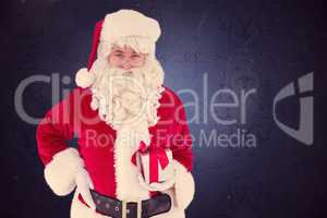Composite image of happy santa claus holding a gift