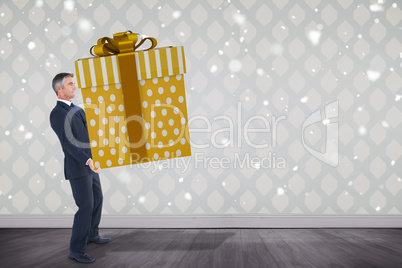 Composite image of stylish man with giant gift