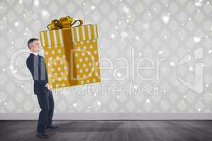 Composite image of stylish man with giant gift