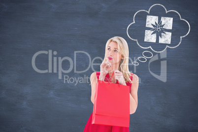 Composite image of stylish blonde in red dress opening gift bag