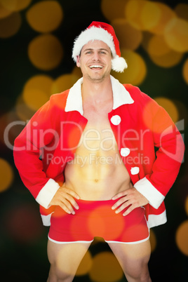 Composite image of smiling muscular man posing in sexy santa out