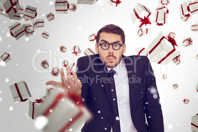 Composite image of doubtful businessman with glasses gesturing