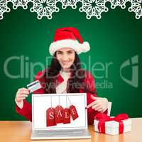 Composite image of festive brunette shopping online