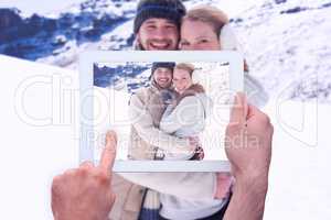 Composite image of hand holding tablet pc