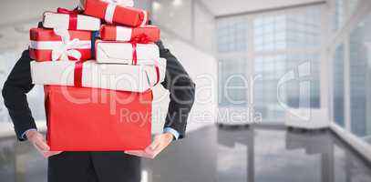 Composite image of businessman holding something with his hands