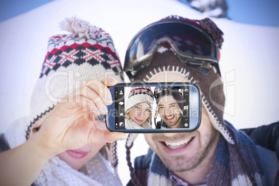 Composite image of hand holding smartphone showing