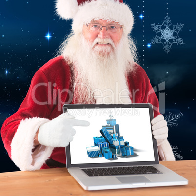 Composite image of happy santa showing laptop screen