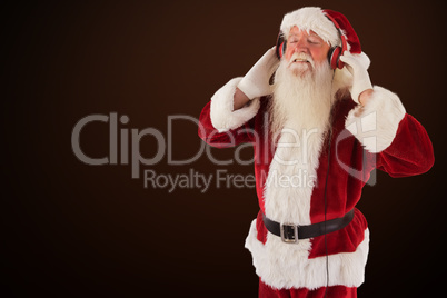 Composite image of santa claus enjoys some music