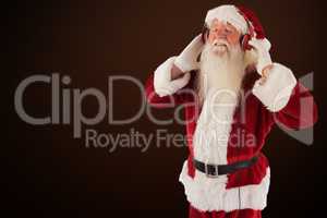 Composite image of santa claus enjoys some music