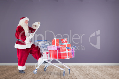 Composite image of santa delivering gifts from cart