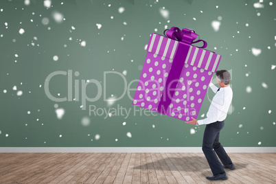 Composite image of stylish man with giant gift