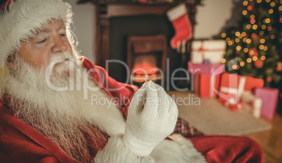 Santa claus holding engagement ring