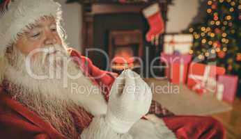 Santa claus holding engagement ring