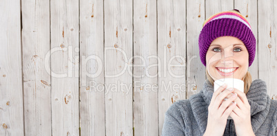 Composite image of smiling woman in a grey pullover against whit