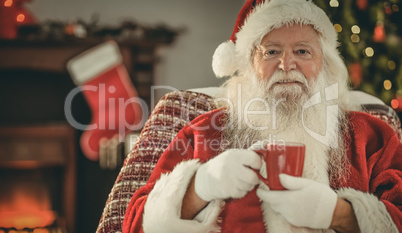 Smiling santa claus holding a mug