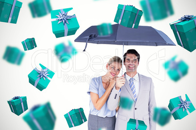 Composite image of business people holding a black umbrella