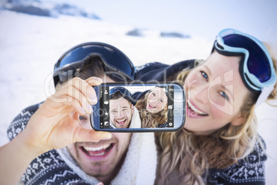 Composite image of hand holding smartphone showing