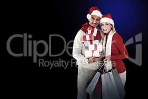 Happy festive couple with gifts and bags