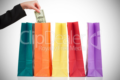 Composite image of businesswomans hand holding hundred dollar bi