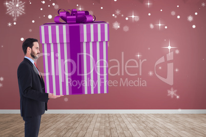 Composite image of stylish man with giant gift