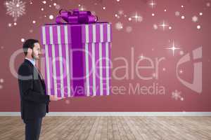 Composite image of stylish man with giant gift