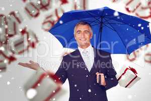 Composite image of smiling businessman holding blue umbrella wit