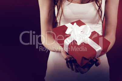 Woman holding red and white gift