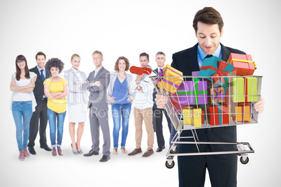 Composite image of businessman holding something with his hands