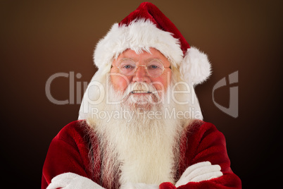 Composite image of santa smiles with folded arms