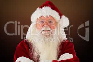 Composite image of santa smiles with folded arms