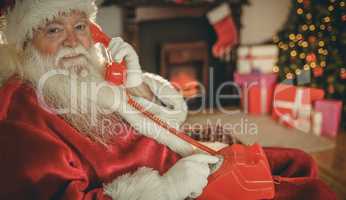 Smiling santa making a phone call