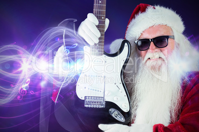 Composite image of father christmas shows a guitar