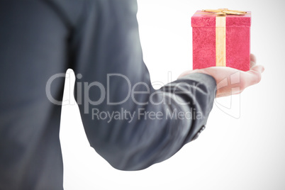 Composite image of businessman holding hand out in presentation