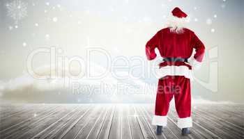 Composite image of santa standing with hands on hips