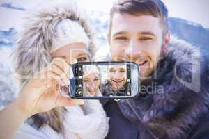 Composite image of hand holding smartphone showing