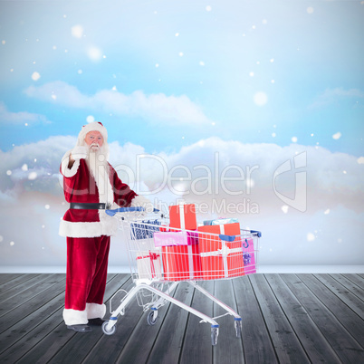 Composite image of santa pushing a shopping cart