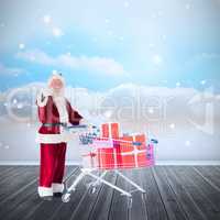 Composite image of santa pushing a shopping cart