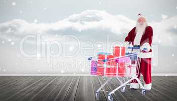 Composite image of santa delivering gifts from cart