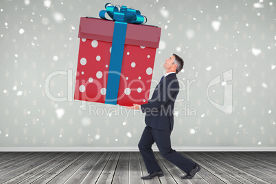 Composite image of stylish man with giant gift