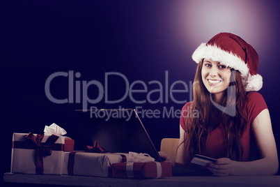 Festive redhead shopping online with laptop Festive redhead shopping online with laptop