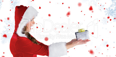 Composite image of sexy santa girl holding gift