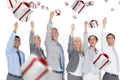 Composite image of smiling business people raising hands