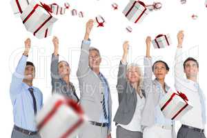 Composite image of smiling business people raising hands